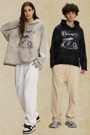 Distressed graphic oversized hoodie in black and gray with ripped details and a bold print.
