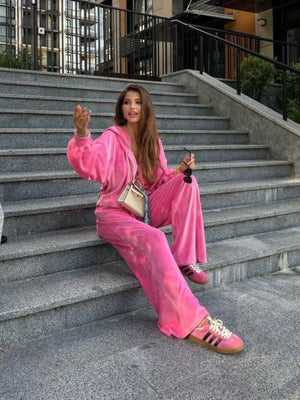 Plush velour lounge set in hot pink with wide leg pants and a zip-up hoodie.