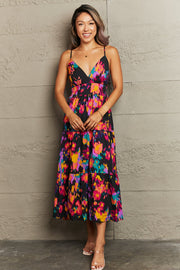 Abstract brushstroke midi dress with V-neck and tiered skirt in black with multicolor print.