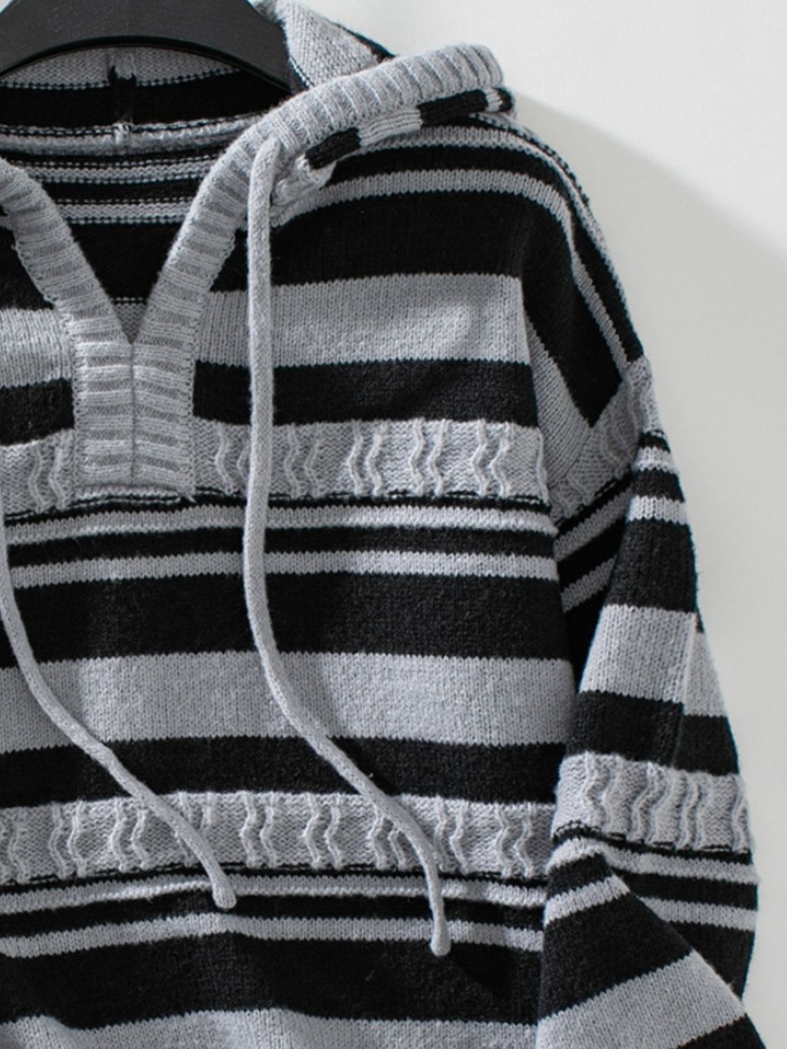 Textured stripe knit hoodie with V-neck in dark gray and white, featuring drawstring hood.
