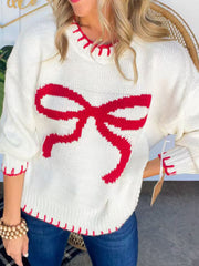 Ivory knit sweater with red bow detail and contrast stitching.