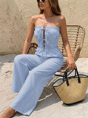 Blue striped strapless romper with smocked waist and tie front detail.