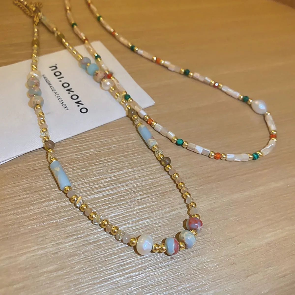 Multi-strand gemstone collar necklace with gold beads and pearls, multicolor and light blue stones