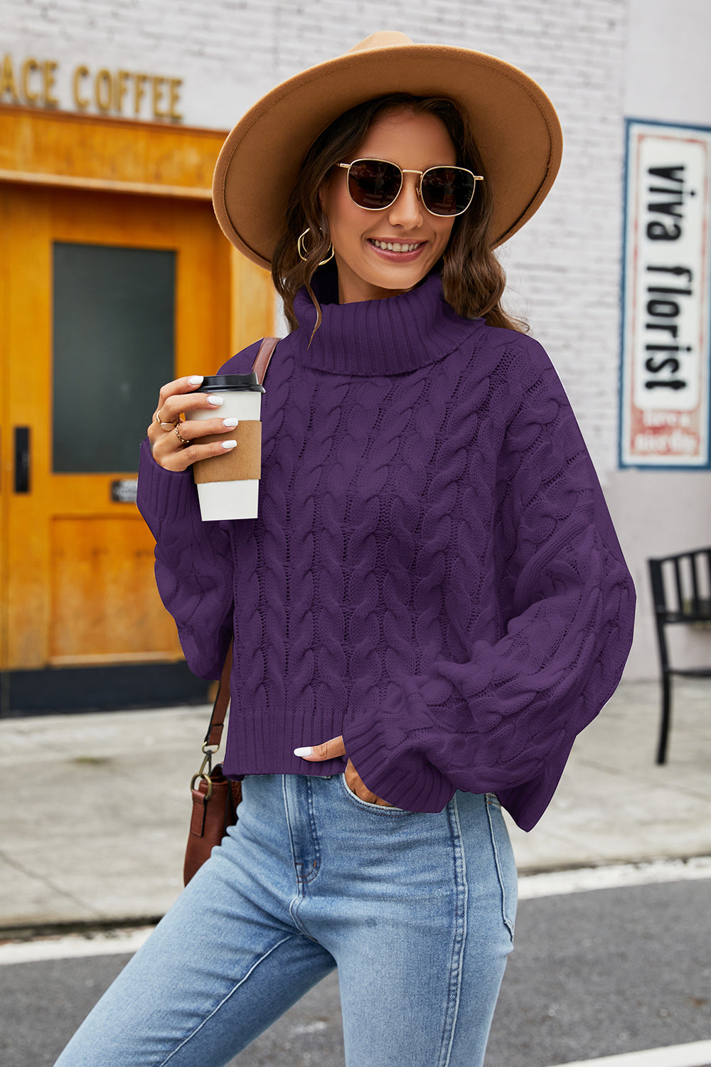 Plum cable knit turtleneck sweater with a cropped length and wide sleeves.