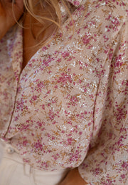 Dusty pink floral print blouse with metallic threads, relaxed fit, button-down detail.