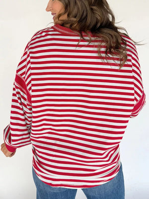 Red and white striped cotton sweatshirt with a V-neck and long sleeves.