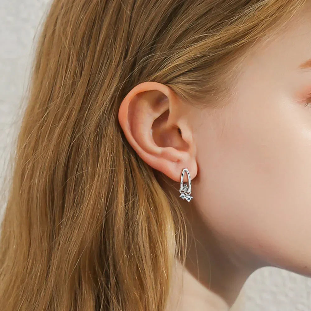 Silver cubic drop hoop earrings with clear stones detail.