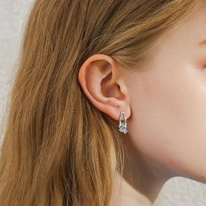 Silver cubic drop hoop earrings with clear stones detail.