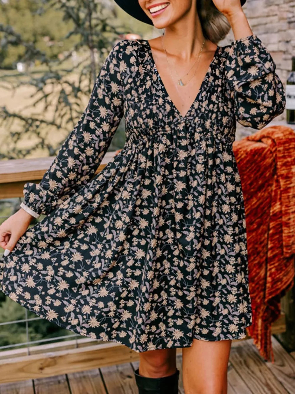 Floral babydoll dress with deep V neckline, bubble sleeves, and above-knee length.