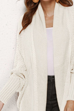 Ivory cocoon knit cardigan with shawl collar and batwing sleeves.