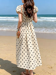 Charming puff sleeve polka dot midi dress with a belted waist and pockets.