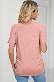 Dusty pink tee with short sleeves, V-neck, and ruched sides.