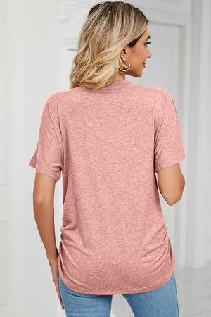 Dusty pink tee with short sleeves, V-neck, and ruched sides.
