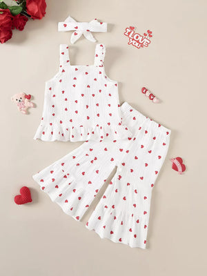 White baby set with red heart print, ruffled hem tank top, flared pants, and matching headband.