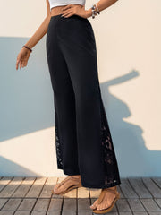 Black palazzo trousers with lace insets on the sides.
