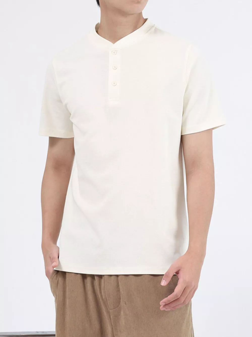 Men's apricot cotton henley t-shirt with button placket and short sleeves.