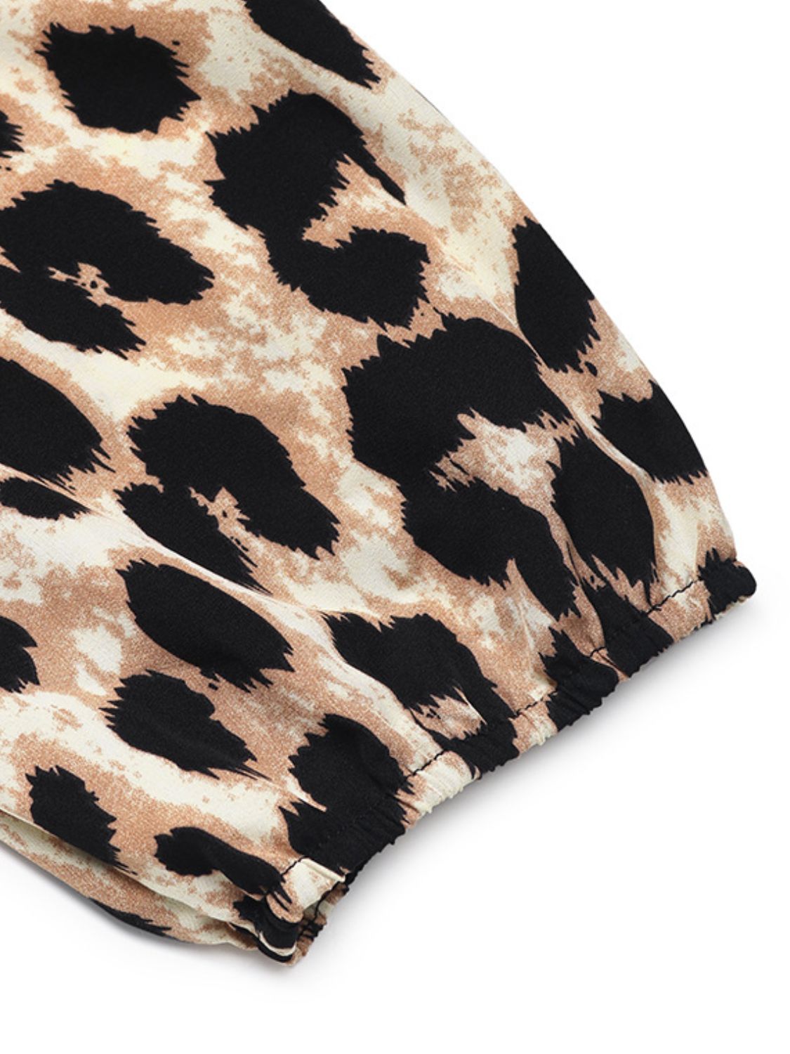 Leopard print puff sleeve jumpsuit detail showing elastic cuff