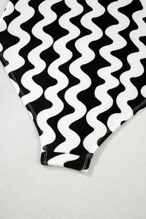 Black and white wave print one-piece swimsuit with textured fabric and ribbed trim.