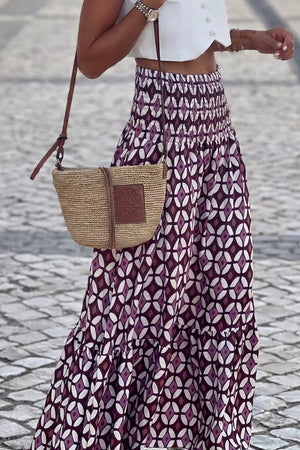 Maxi skirt with smocked waist and geometric print in purple and white.