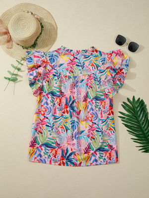 Tropical floral print cotton blouse with ruffled short sleeves and high neckline.