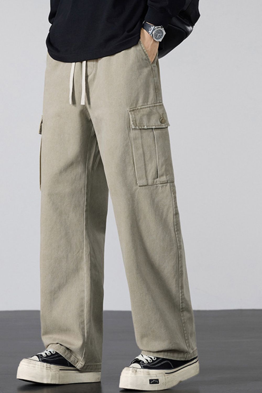 Khaki relaxed fit cargo sweatpants with drawstring and button flap pockets.