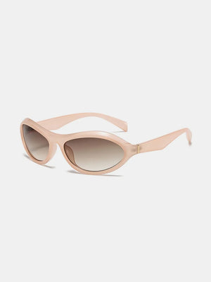 Blush pink sculpted oval lens sunglasses with gradient brown lenses.