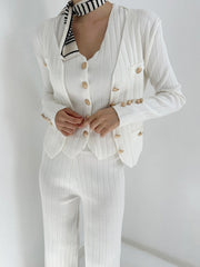 White ribbed knit outfit set with gold buttons and a striped scarf.