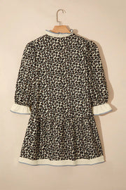 Leopard print mini dress with ruffled mock neck, tiered skirt, and striped trim cuffs and hem.