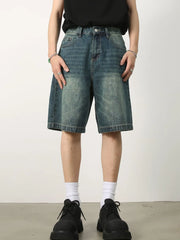 Baggy denim bermuda shorts in light blue with a washed effect and buttoned fly.