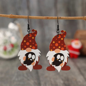 Spotted gnome wood dangle earrings in deep red with orange polka dots and ghost faces.