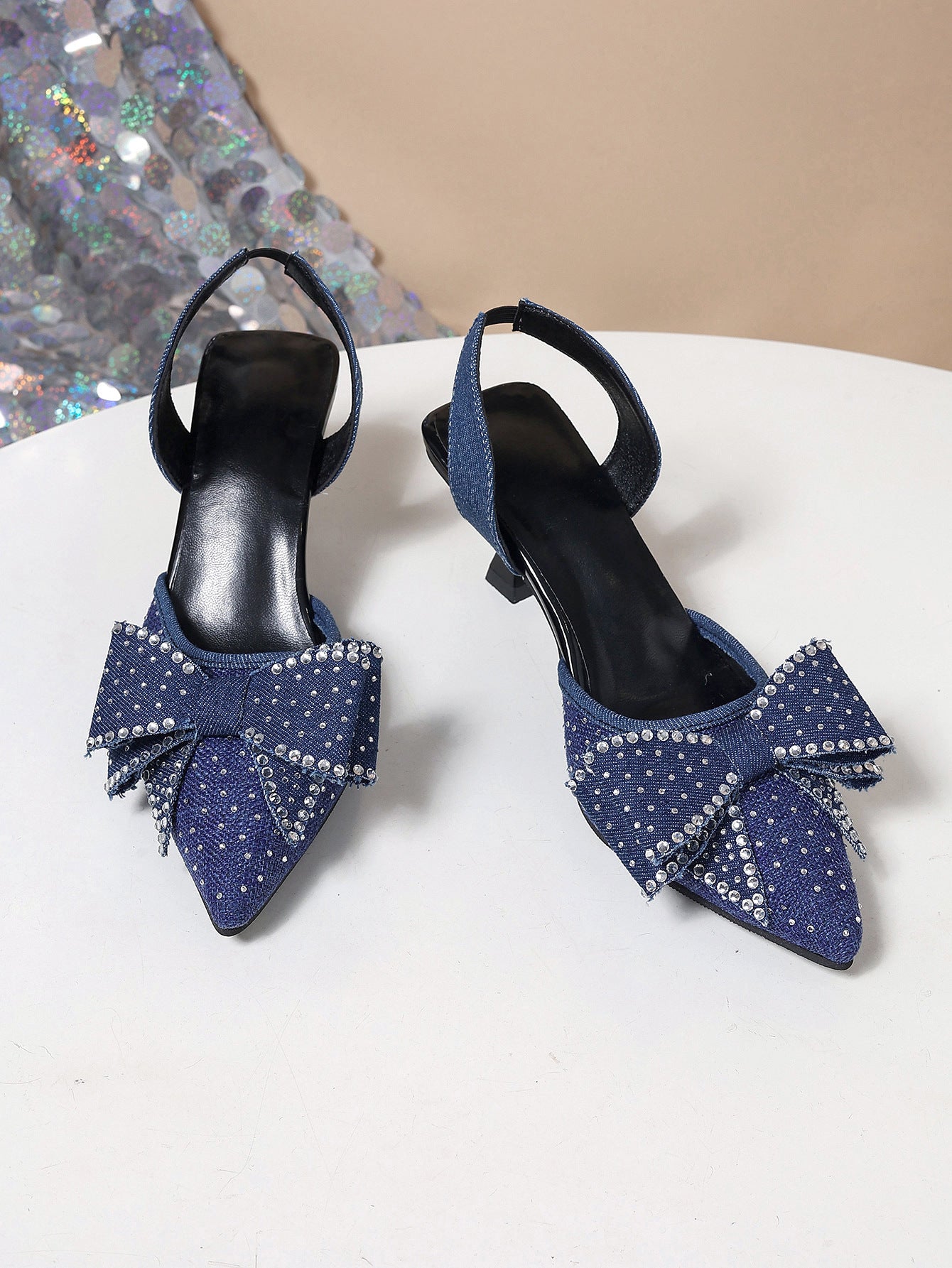 Blue denim slingback heels with rhinestone bowknot detail