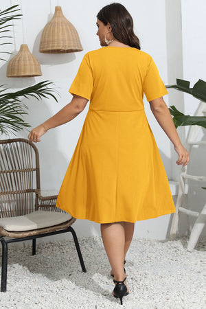 Mustard yellow midi dress with short sleeves and a flared skirt.