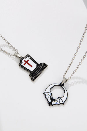 Spooky Season enamel pendant necklaces, one tombstone with red cross, one bat in circle.
