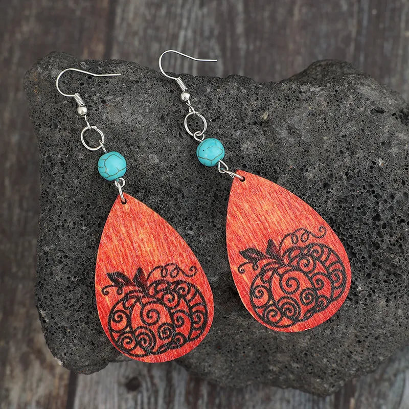 Autumnal pumpkin wood dangle earrings with turquoise beads and silver hooks.