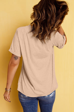 Tan t-shirt with rolled sleeves and a graphic detail on the arm.