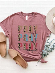 Textured graphic t-shirt in blush pink with leopard print and text graphic.