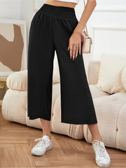 Black smocked waist culotte trousers with a wide leg and cropped length.
