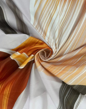 Chic floral maxi dress fabric detail with cowl neck and backless design in orange and white.
