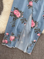 Denim skirt with pink floral print and front slit detail.