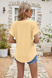 Light yellow perforated sleeve tee with rolled cuffs and a curved hem.
