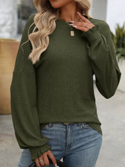 Army green ribbed knit blouse with ruffled cuffs and balloon sleeves.