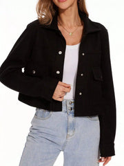 Black trucker jacket with snap buttons and chest pockets, worn over a white tank top.
