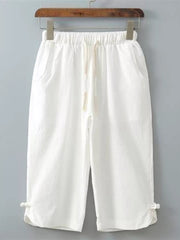 White cropped sweatpants with drawstring waist and tie detail at hem
