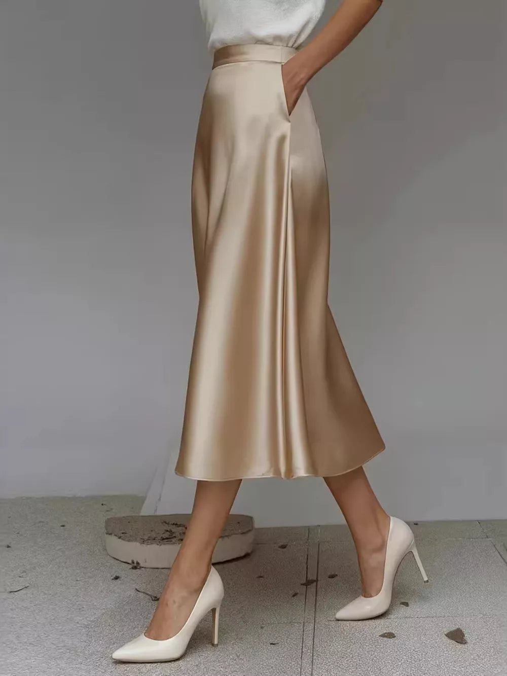 Elegant A-line satin skirt in Khaki Color with pockets and a flowing silhouette.