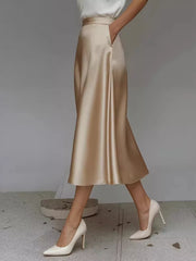 Elegant A-line satin skirt in Khaki Color with pockets and a flowing silhouette.