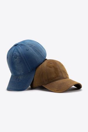 Two distressed baseball caps, one navy and one chestnut, with adjustable straps.