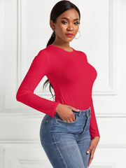 Red long sleeve ribbed bodysuit with crew neck, styled with jeans.