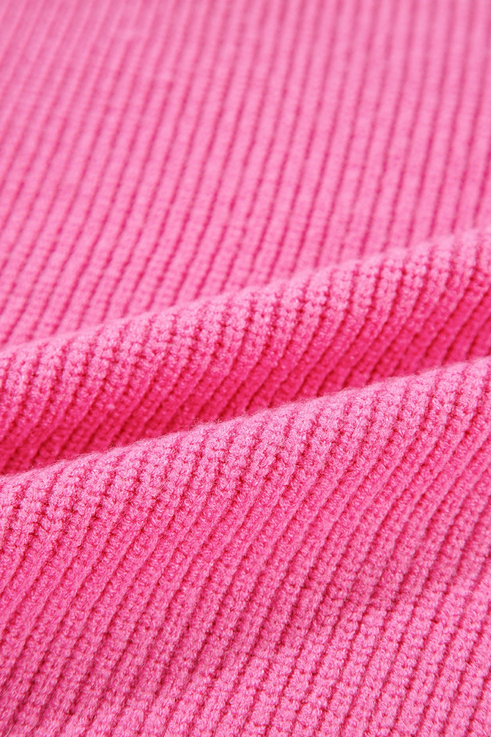 Fuchsia pink ribbed knit tank top showing texture and drape.