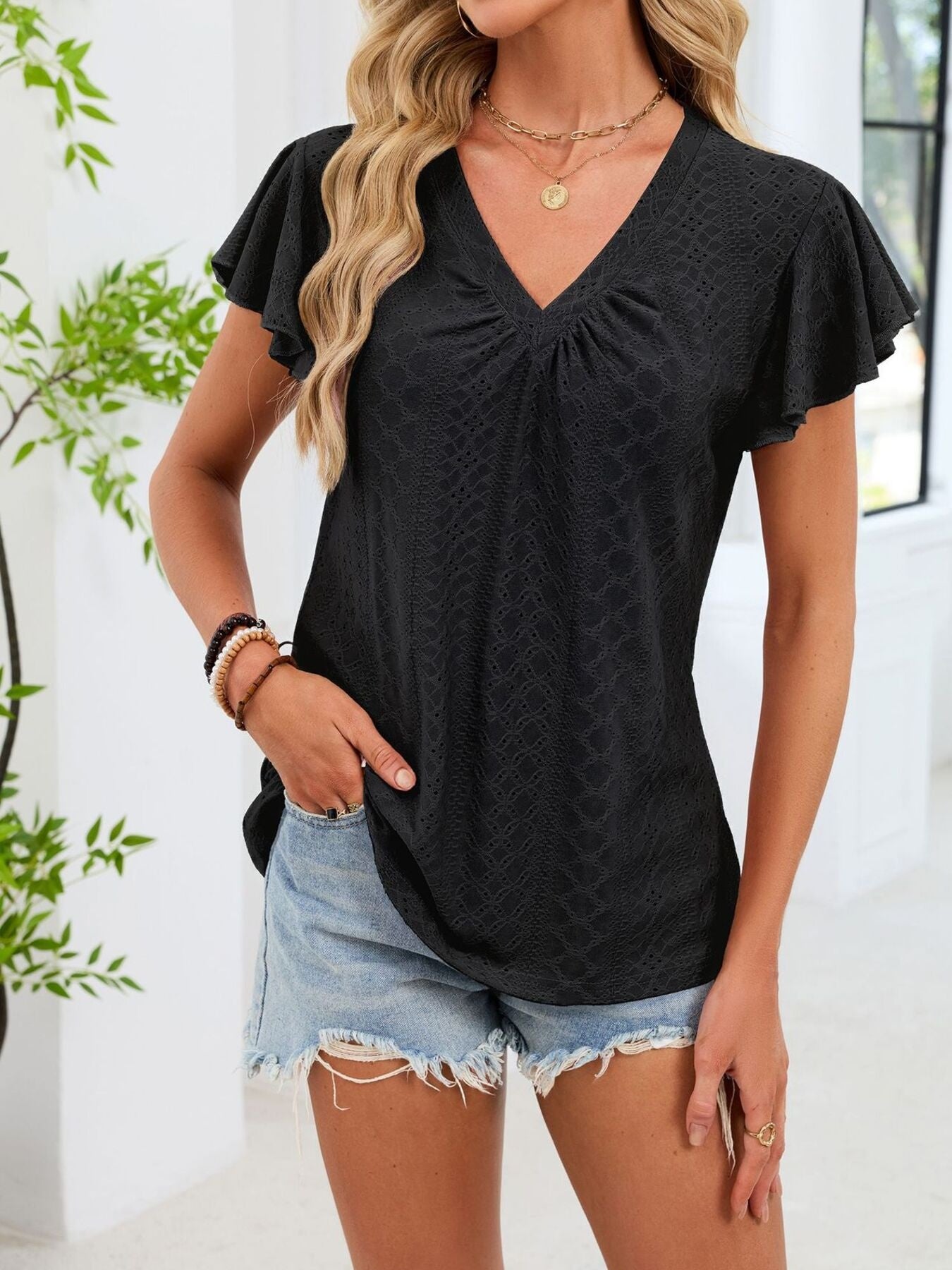 Black flutter sleeve ruched v-neck t-shirt with eyelet detail.