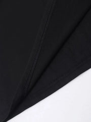Black t-shirt with iridescent heart and cross appliqué detail, showing stitching.